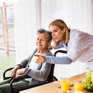Caregiver and senior woman during home visit